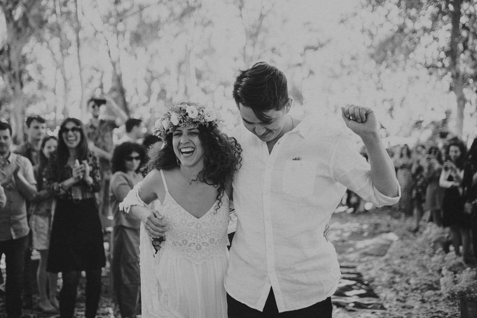 A couple laughing together on the dance floor at their wedding
